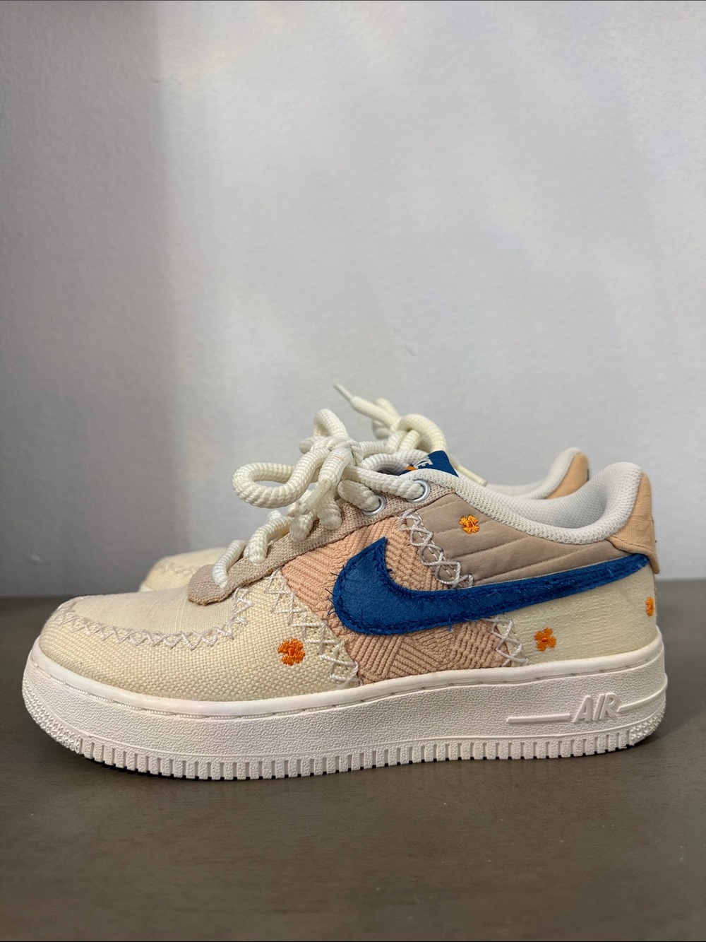 Nike Women's Cream Peach Low-Top Sneakers with Blue Swoosh